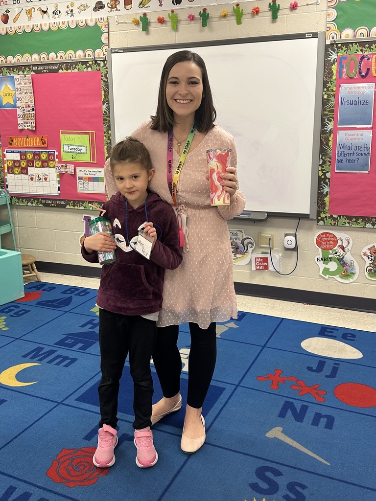 Teacher posed with student dressed as teacher