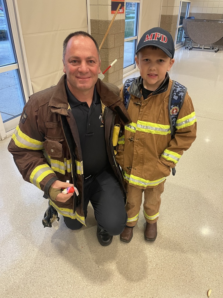 Student dressed as fireman with Galion Fireman