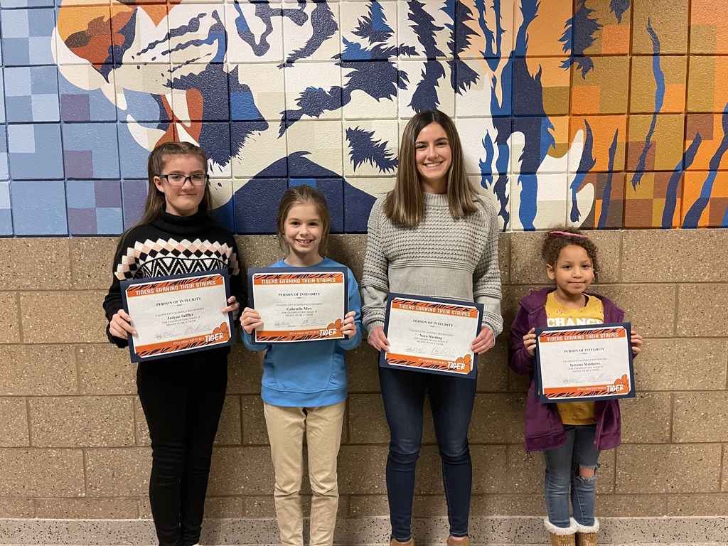 Students recognized for integrity with their certificates.