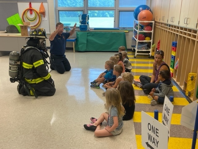 Firefighters reviewing fire safety with students